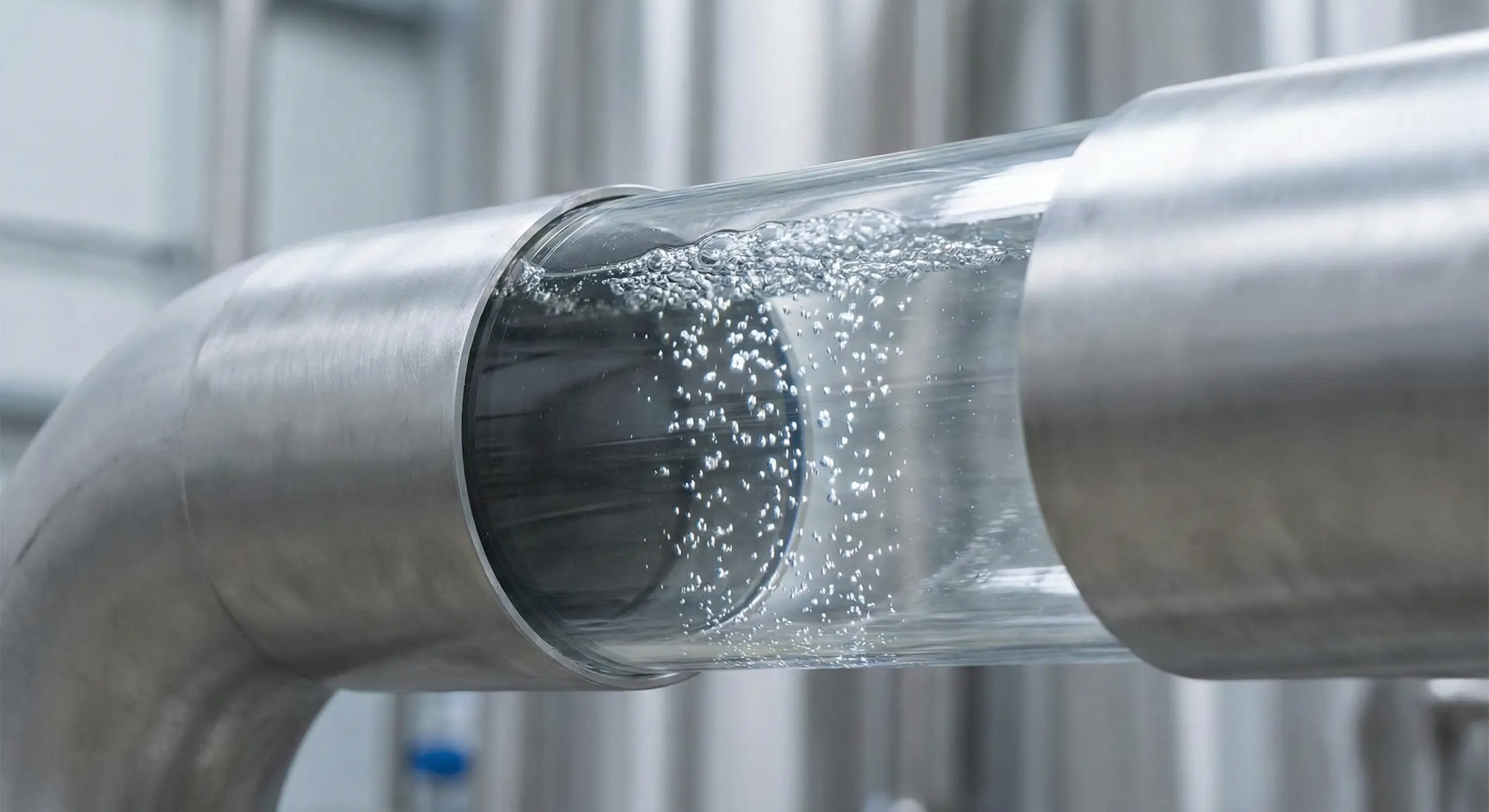 picture of a pipe with a glass side pannel with gas bubbles showing